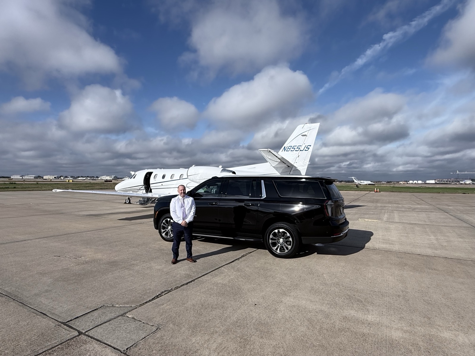 Private car service with luxury SUV and jet
